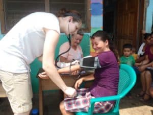 Resident student taking vitals at a local field clinic